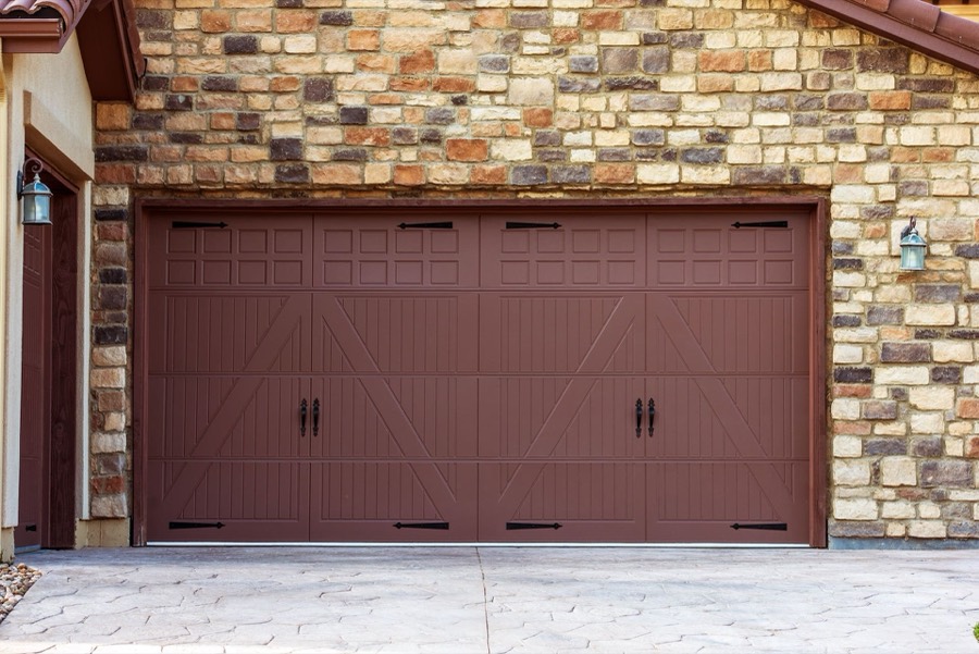 Wide wood garage doors finished with a rich custom stain
